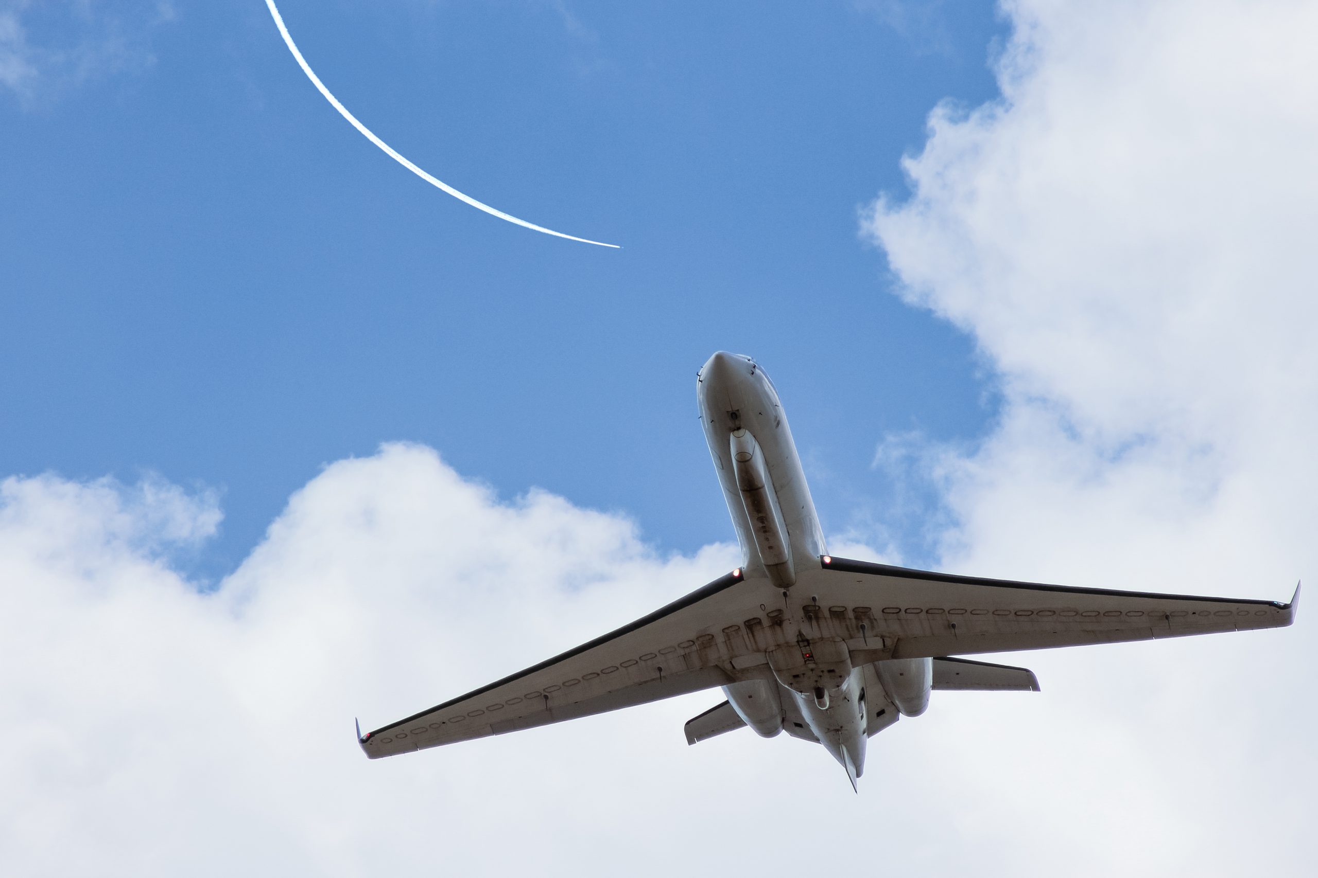 low-angle-view-airplane-flying-against-sky