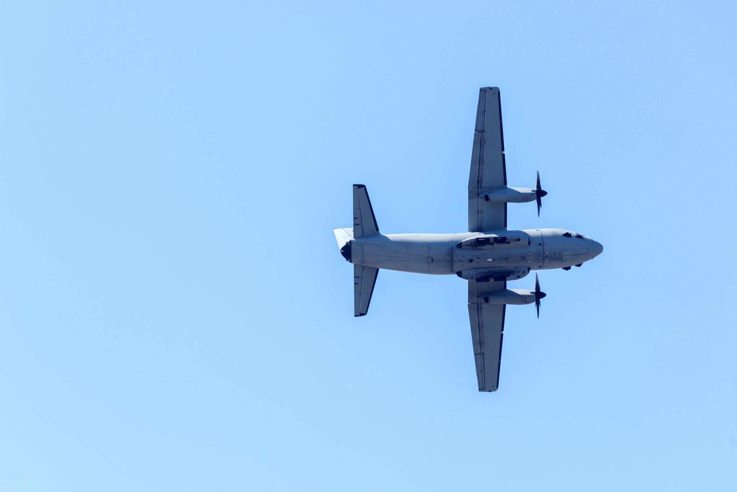 big plane flies against the background of the blue sky